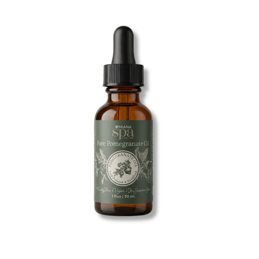 Pure Pomegranate Oil in a Brown glass bottle with a dropper labeled on a white background | Omiana Spa Skincare